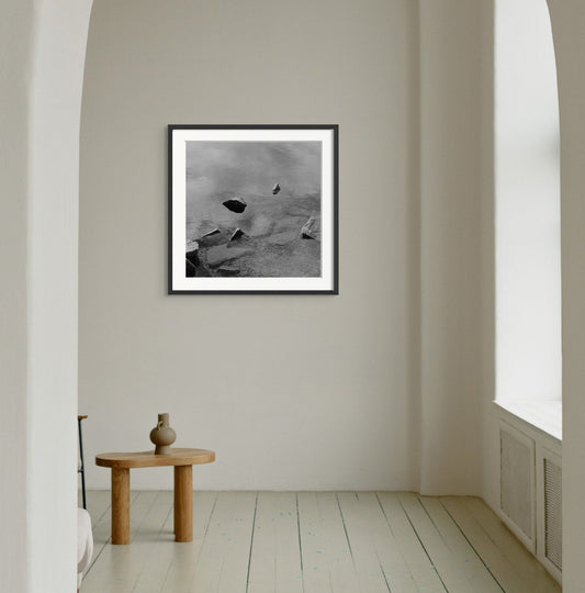 Black and white analog fine art photography print featuring a landscape with a lake and rocks in Norway,  wall art with framing options.