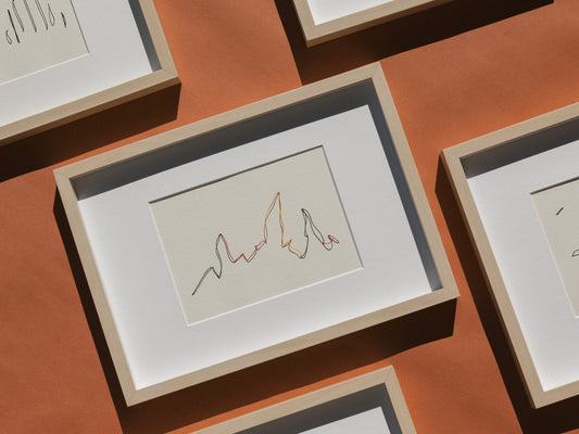 Framed abstract embroidery on paper, an original minimalist artwork that changes with the light, representing mounting in colour