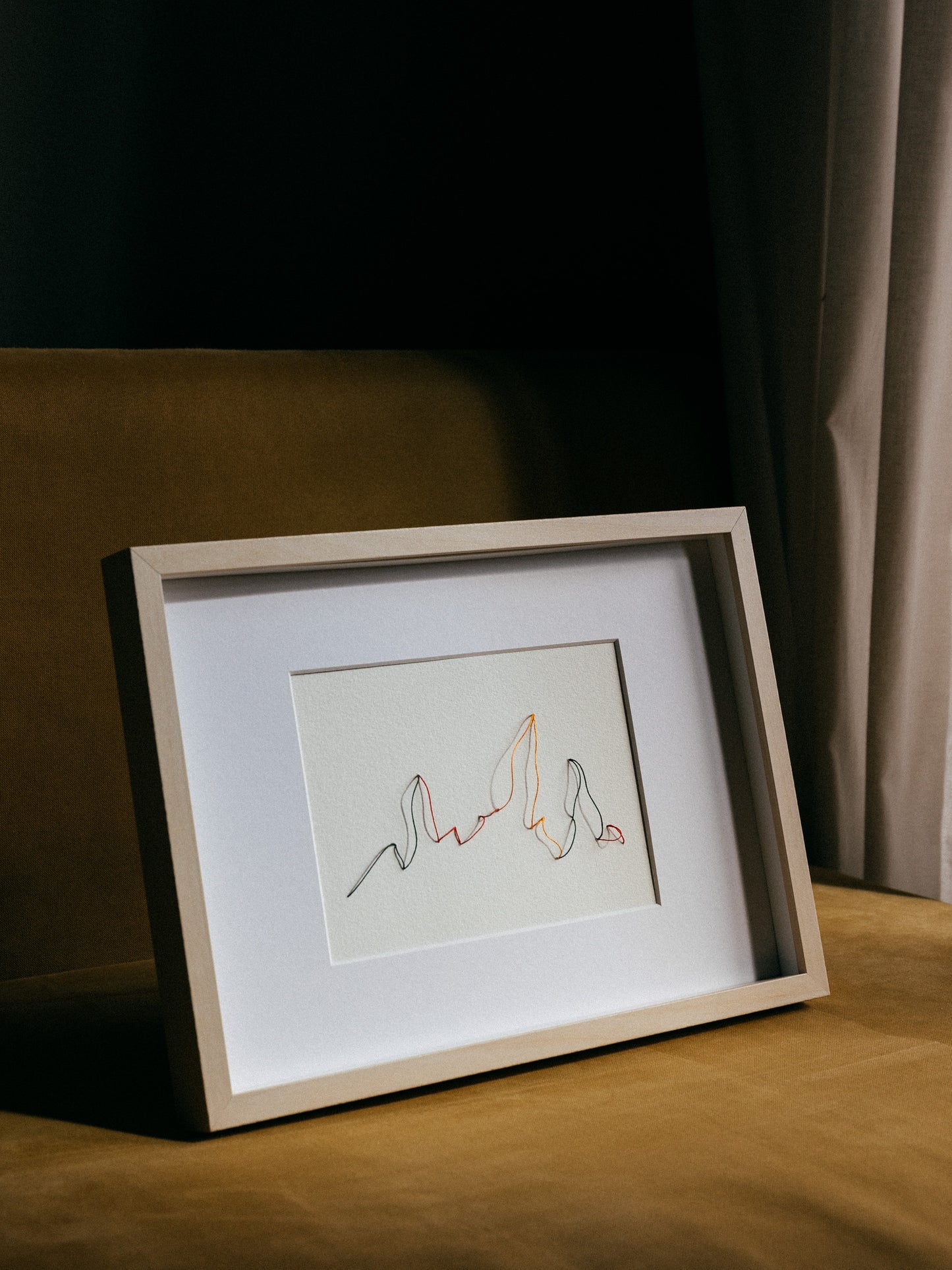 Framed embroidery on paper, an original minimalist artwork that changes with the light
