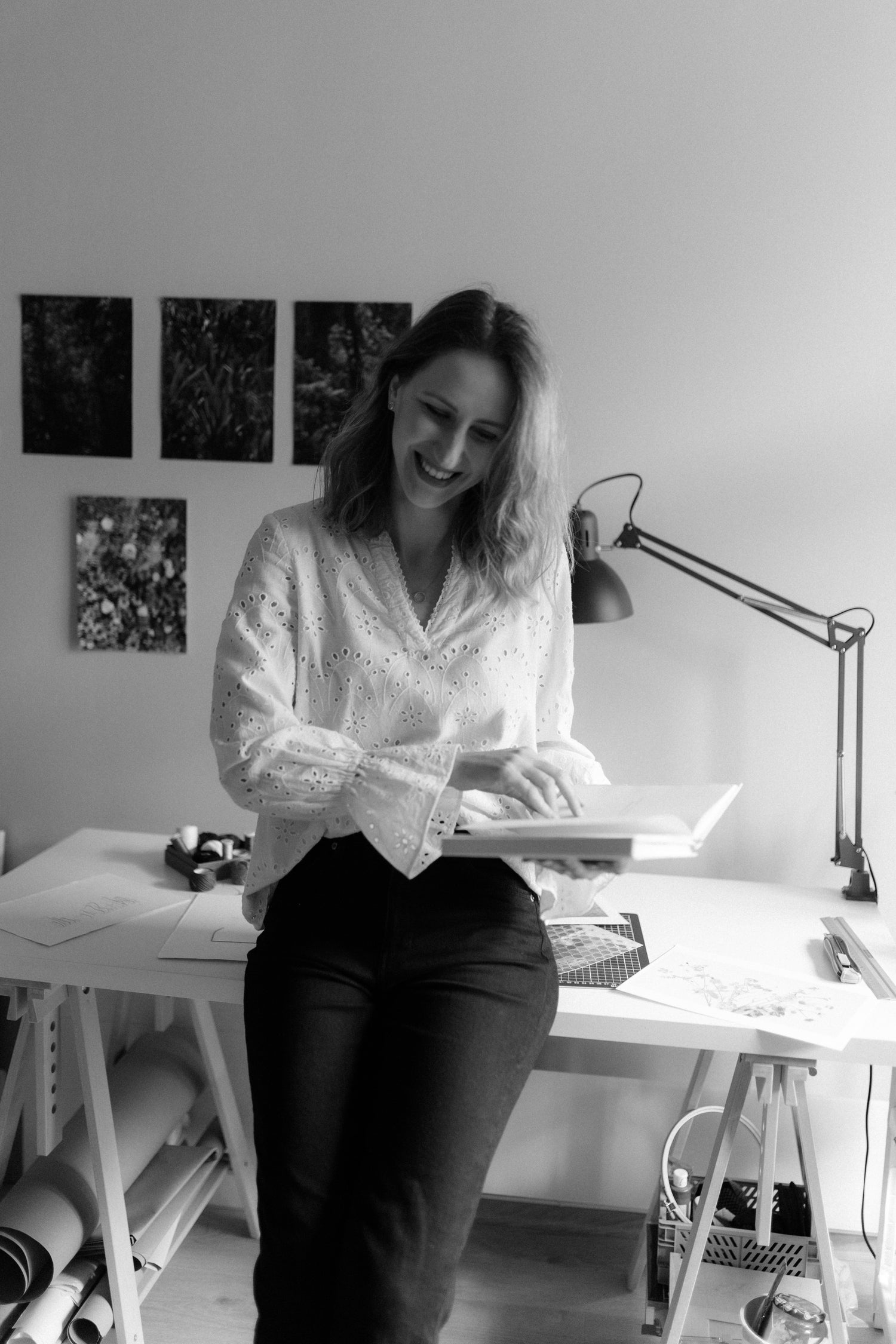 Black and white photo of a photographer in her studio