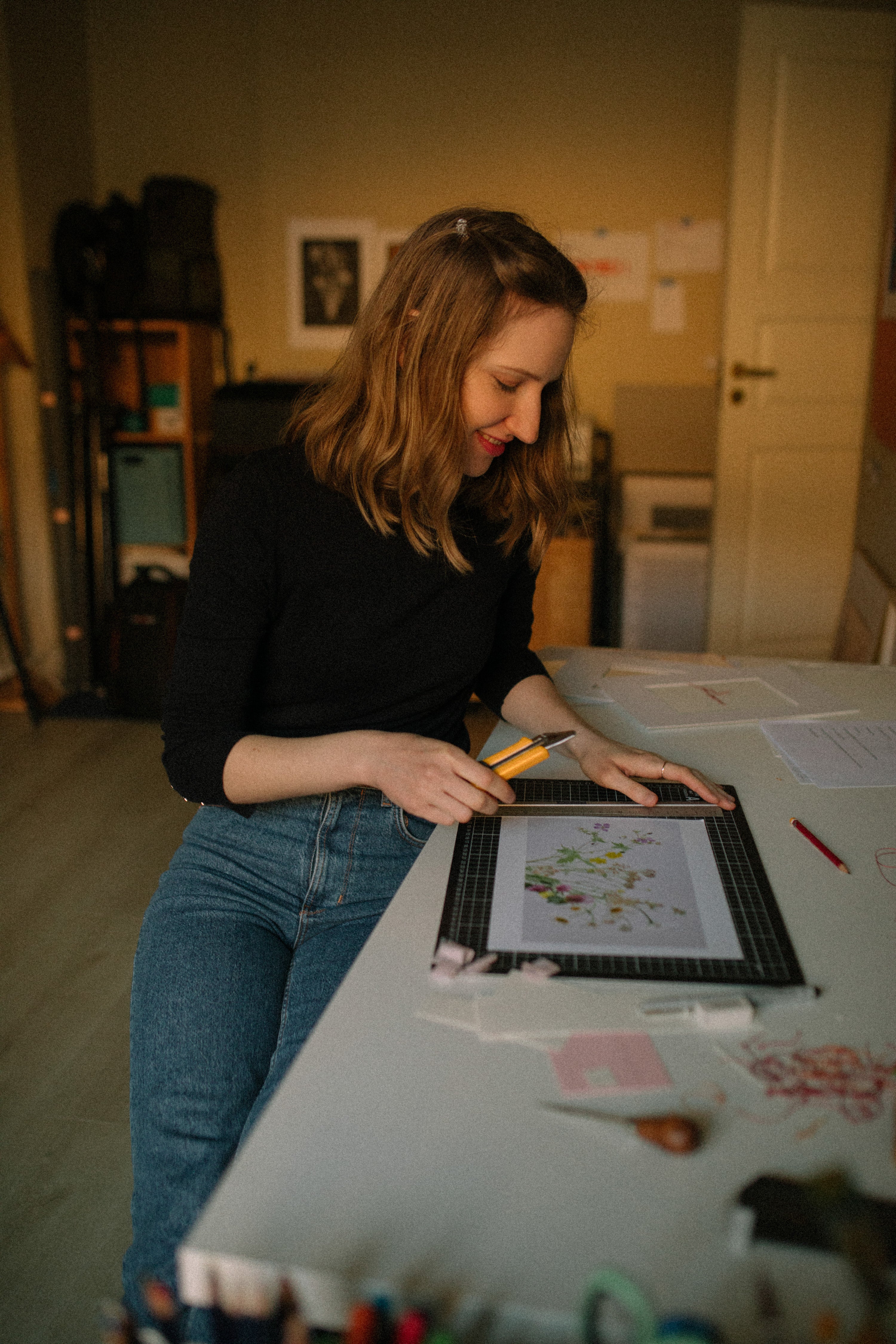 Artist in her art studio working on photography prints