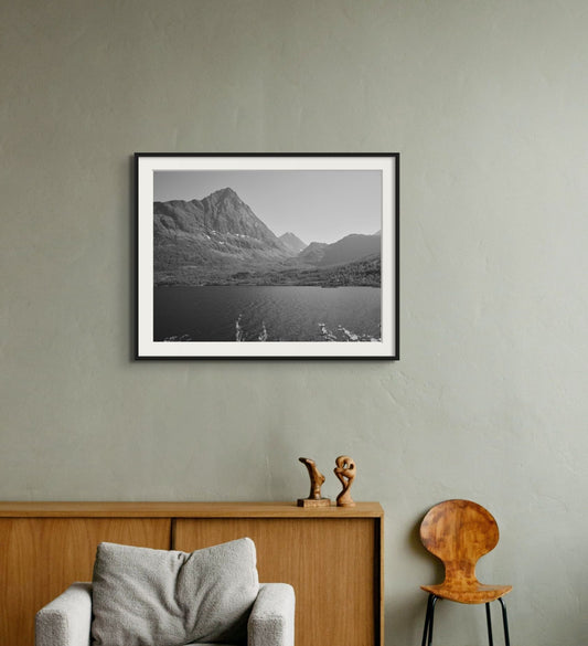 Black and white fine art photography print featuring a mountain and lake landscape, shown in an interior setting, available as wall art with framing options.