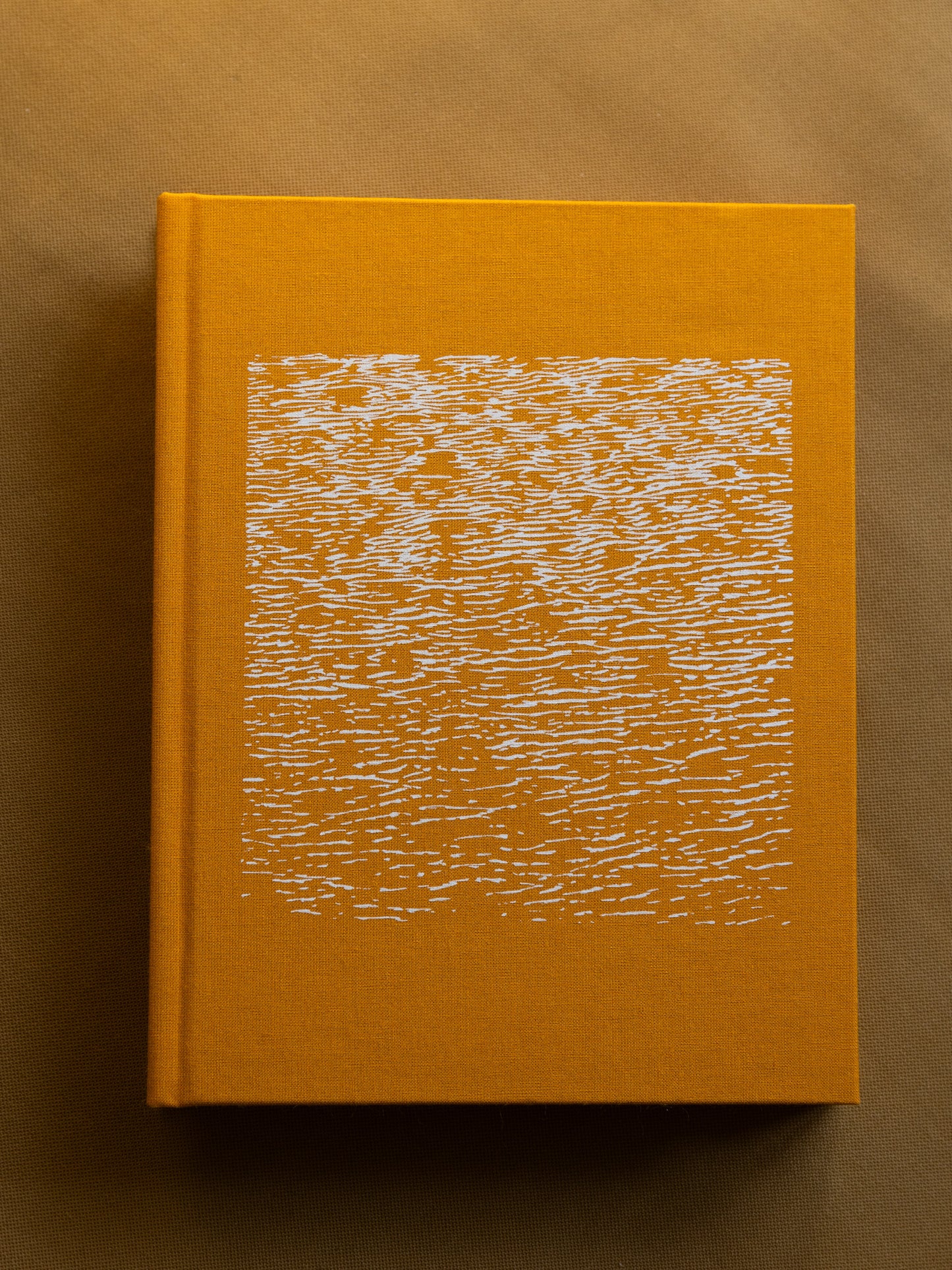 Artist's book titled 'It's a Small Day,' featuring 300 pages of photography and text in a unique two-in-one format, sea textured cover