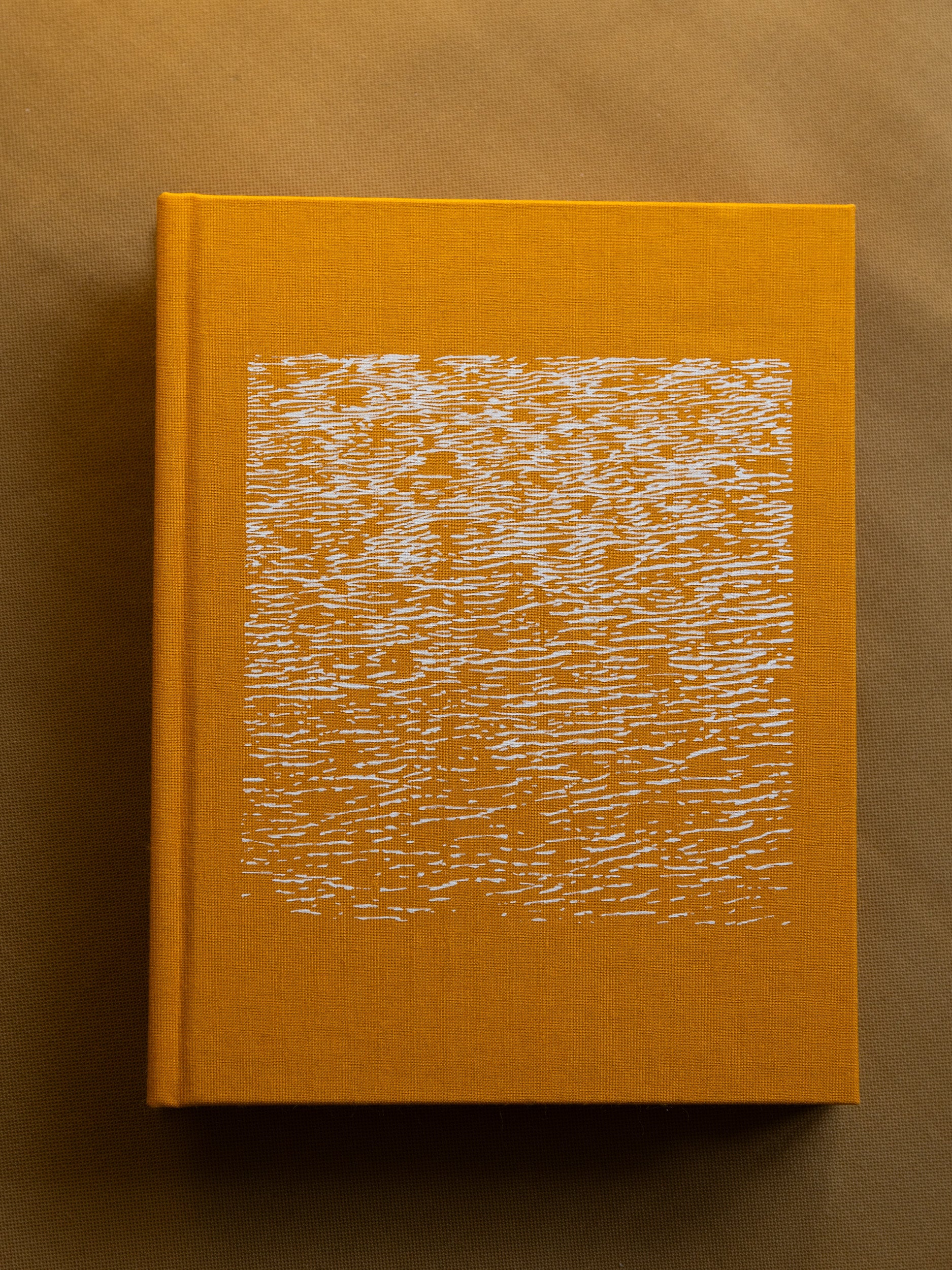 Artist's book titled 'It's a Small Day,' featuring 300 pages of photography and text in a unique two-in-one format, sea textured cover