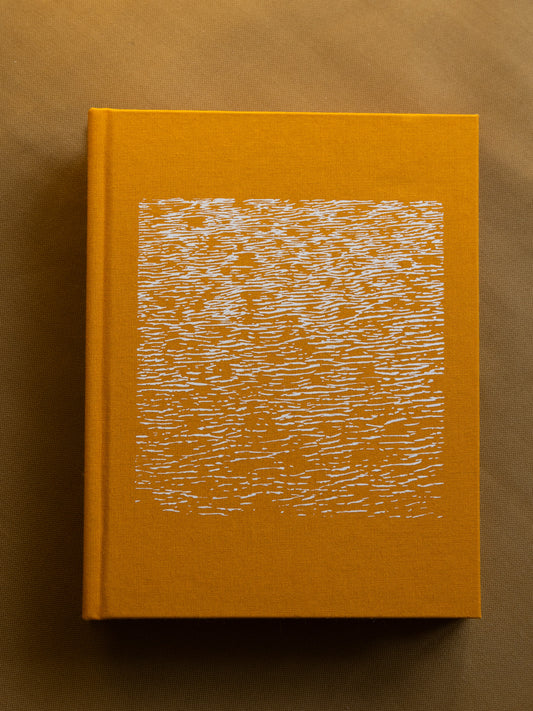 Artist's book titled 'It's a Small Day,' featuring 300 pages of photography and text in a unique two-in-one format, sea textured cover