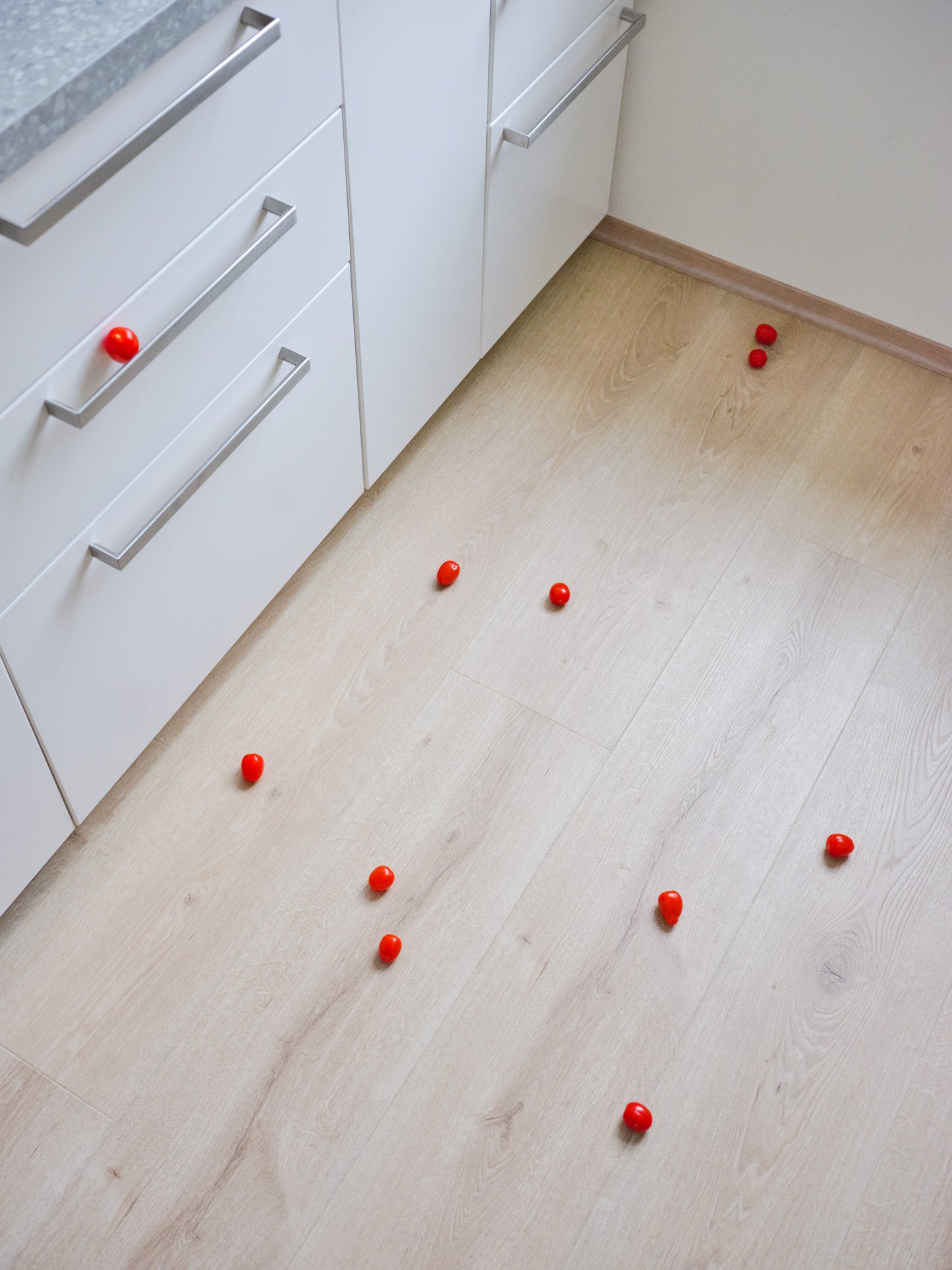 Still-life photography featuring tomatoes on the kitchen floor. Limited edition photography print.