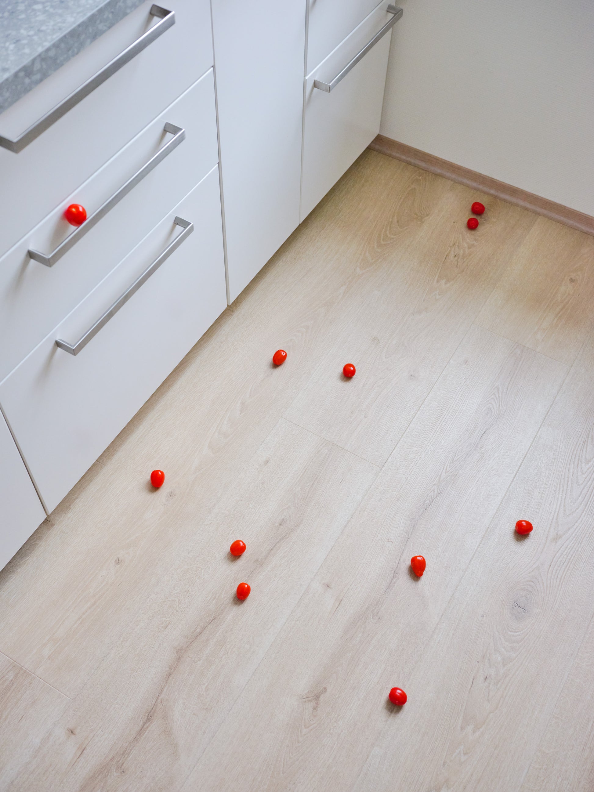Still-life photography featuring tomatoes on the kitchen floor. Limited edition photography print.