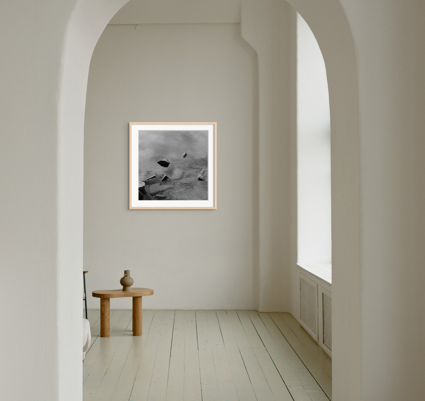 Black and white analog fine art photography print featuring a landscape with a lake and rocks in Norway, wall art in a handmade wooden frame. 