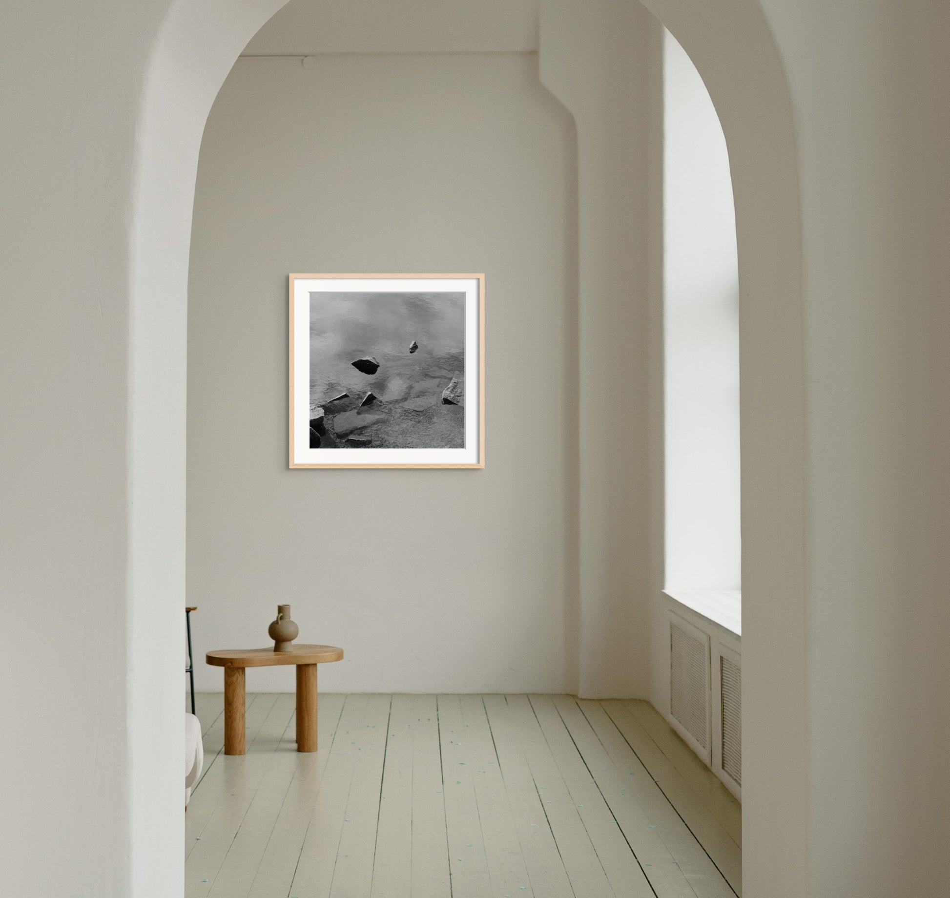 Black and white analog fine art photography print featuring a landscape with a lake and rocks in Norway, wall art in a handmade wooden frame. 
