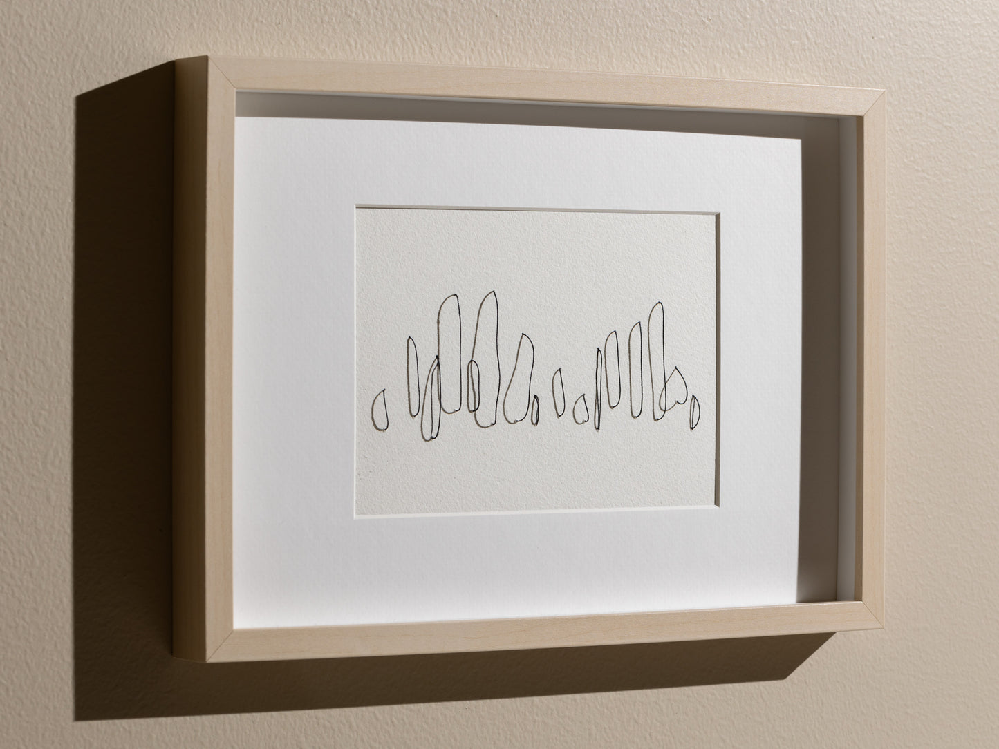 Framed abstract embroidery on paper, an original minimalist relief artwork that changes with the light, angled, dramatic 