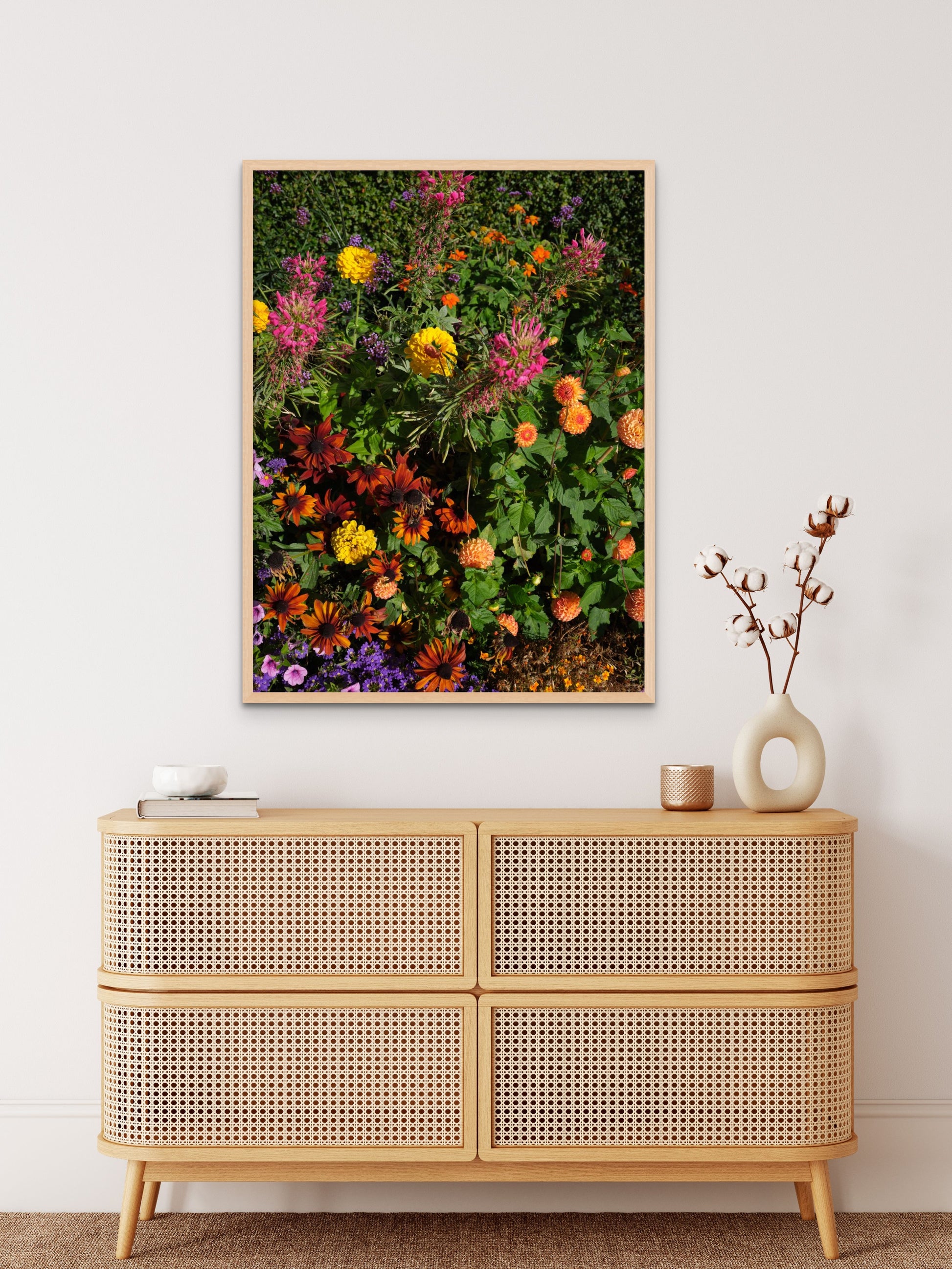 Colorful fine art photography print featuring a vibrant display of flowers, shown in an minimalistic interior setting, available as wall art with framing options.