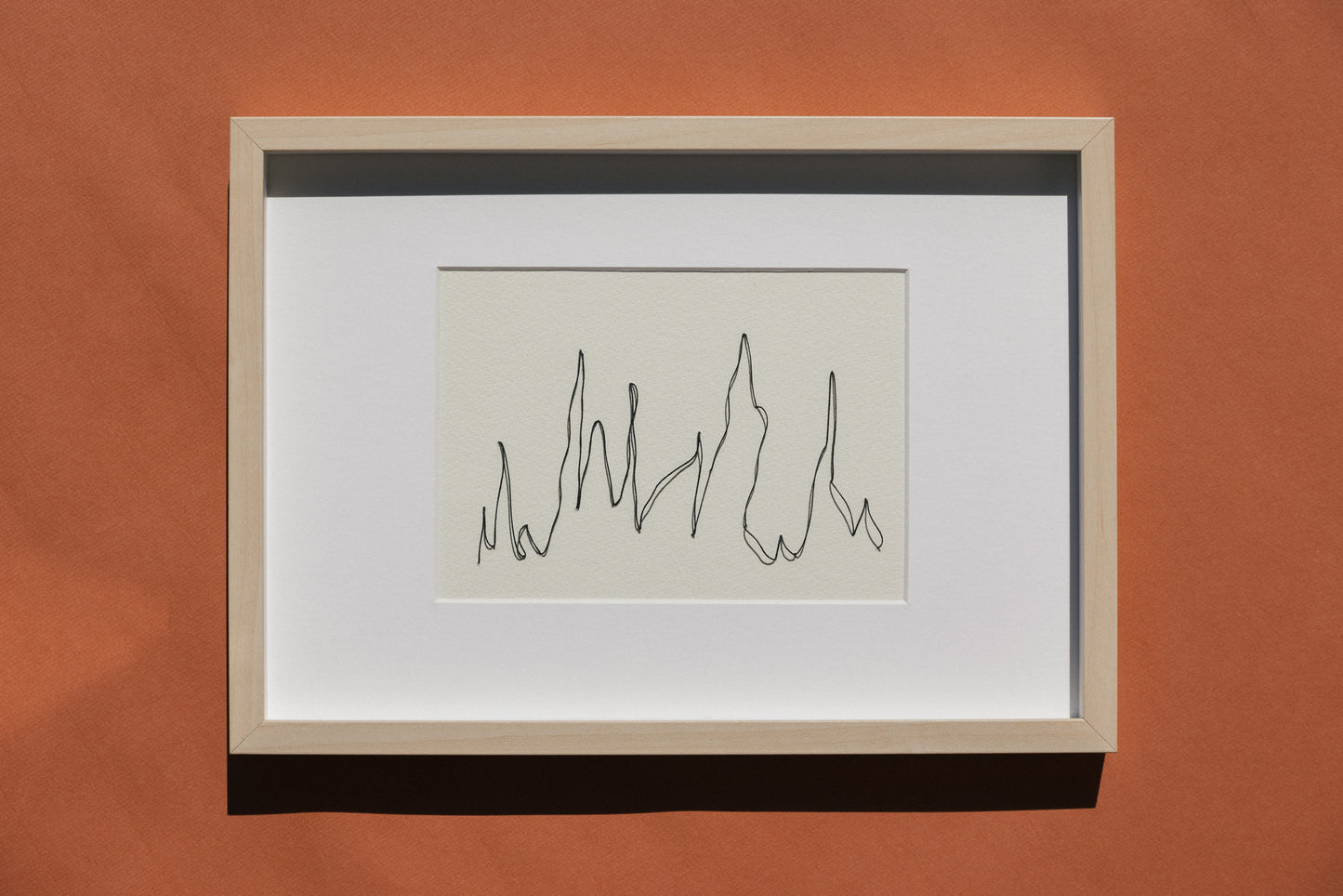 Framed embroidery on paper, an original minimalist artwork that changes with the light, representing mountain 