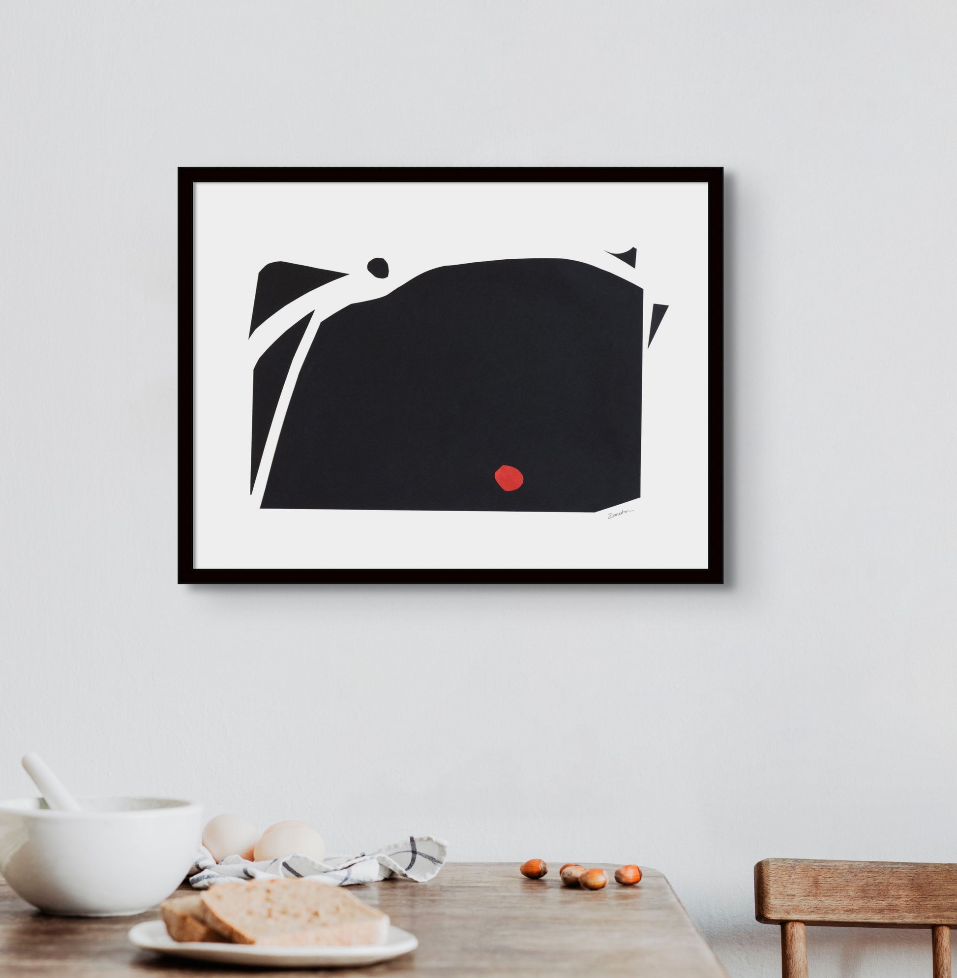 Art print featuring abstract black and red shapes representing mountains, displayed in an interior setting, available as a Giclée print with framing options."