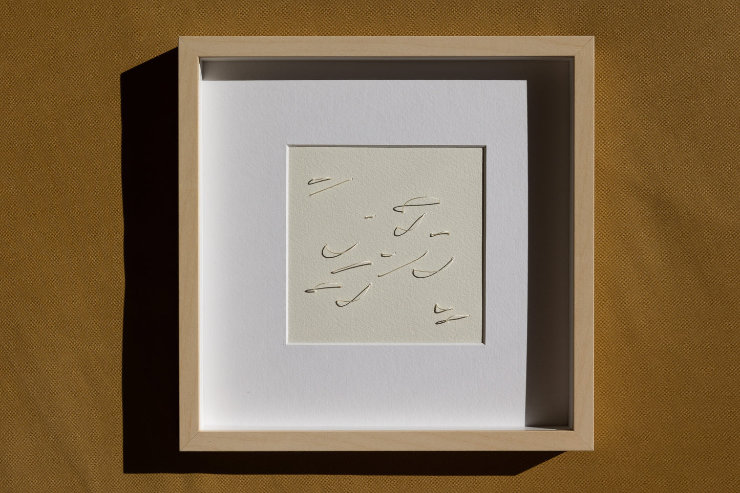 Framed abstract embroidery on paper, an original minimalist relief artwork representing white birds, changing with the light, dramatic.